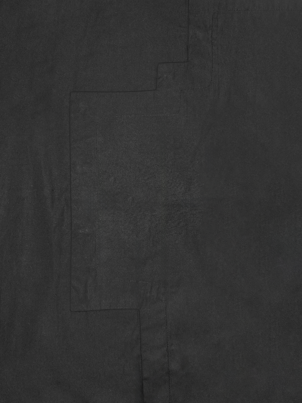 Détail de la chemise en coton Stephen, noire et asymétrique.